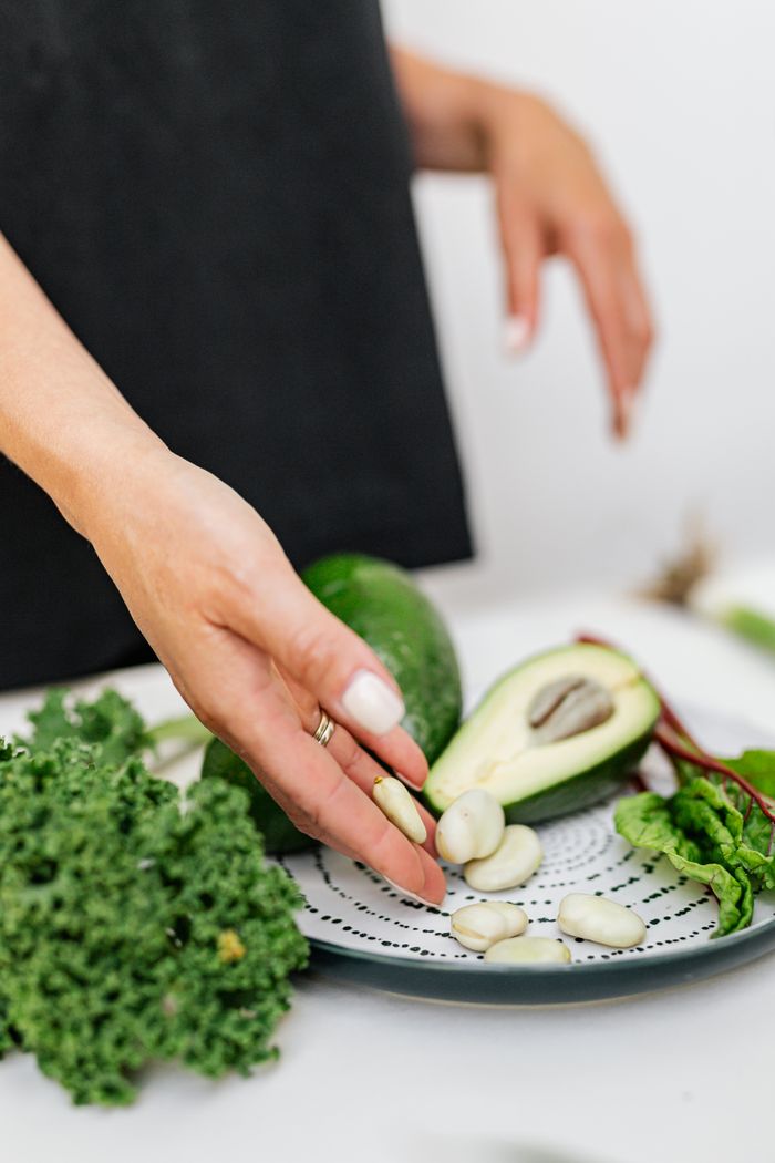 why-choose-us A healthy selection of avocados and broad beans on a plate, showcasing fresh ingredient preparation.